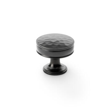 Black textured cabinet knob on white background.