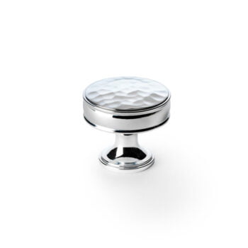 Silver cabinet knob with geometric top on white background.