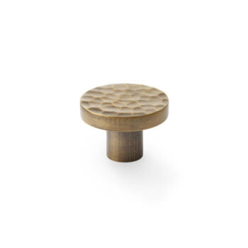 Textured bronze cabinet knob on white background