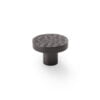 Textured black cabinet knob isolated on white.
