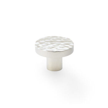 White textured cabinet knob on white background.