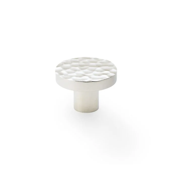 White textured cabinet knob on white background.