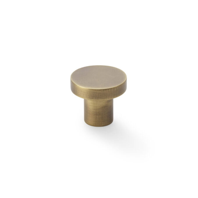 Brass cabinet knob on white background.