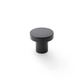 Black cabinet knob on white background