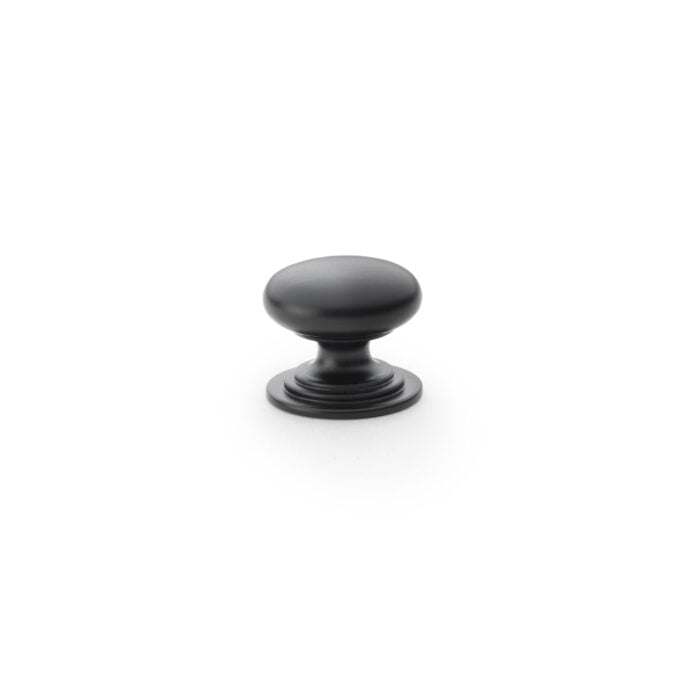 Black cabinet knob on white background