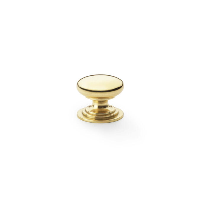 Polished brass cabinet knob on white background