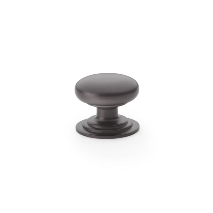 Matte black round cabinet knob on white