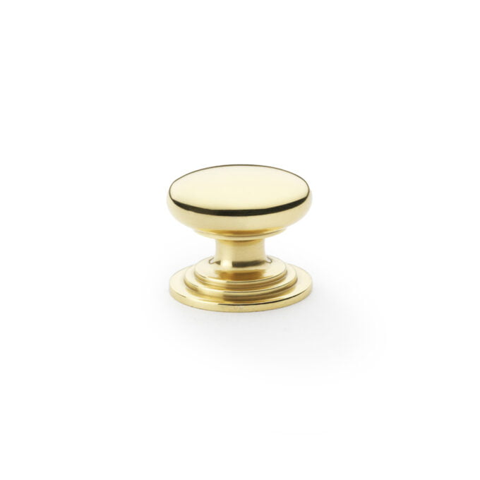 Polished brass cabinet knob on white background