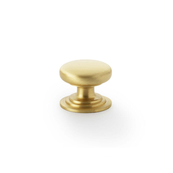 Brass round cabinet knob on white background