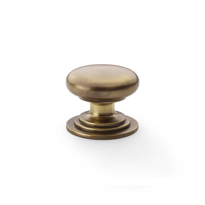 Antique brass cabinet knob isolated on white background.