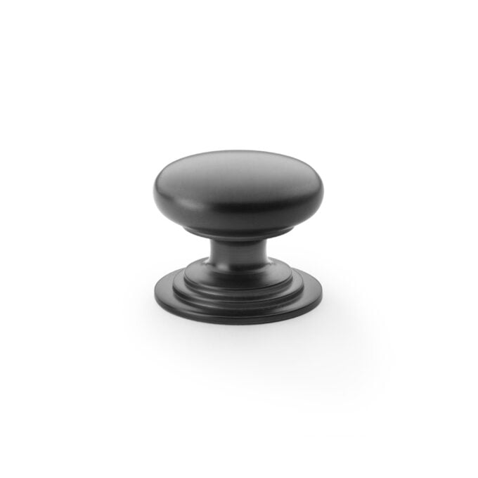 Black metal cabinet knob on white background.