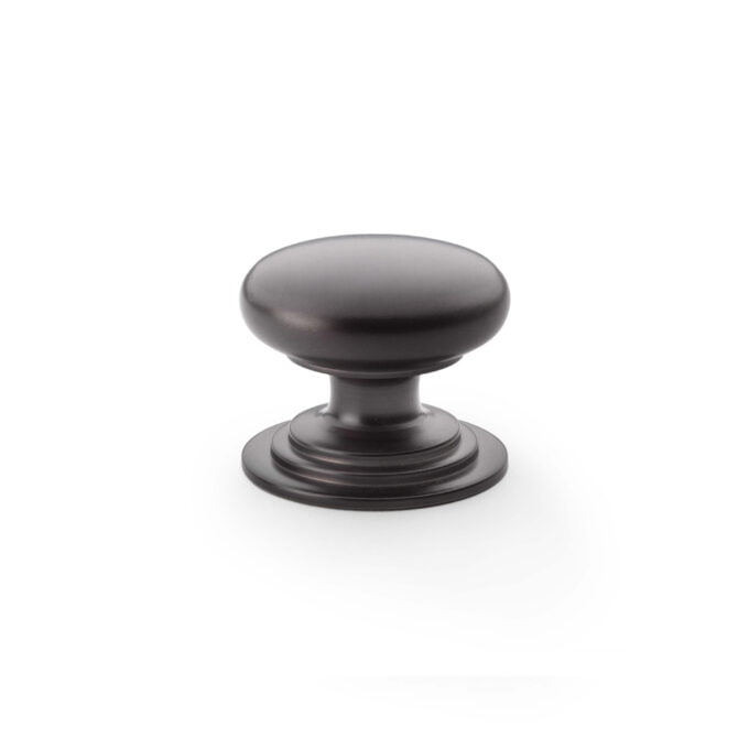 Black metal cabinet knob on white background.