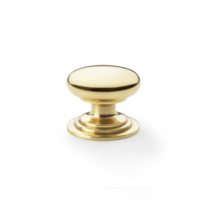 Brass cabinet knob on white background.