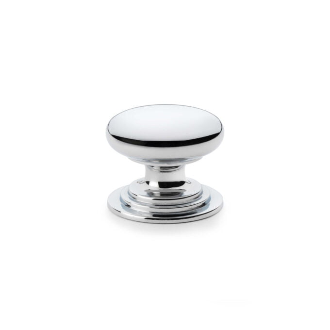 Polished chrome round cabinet knob on white background.