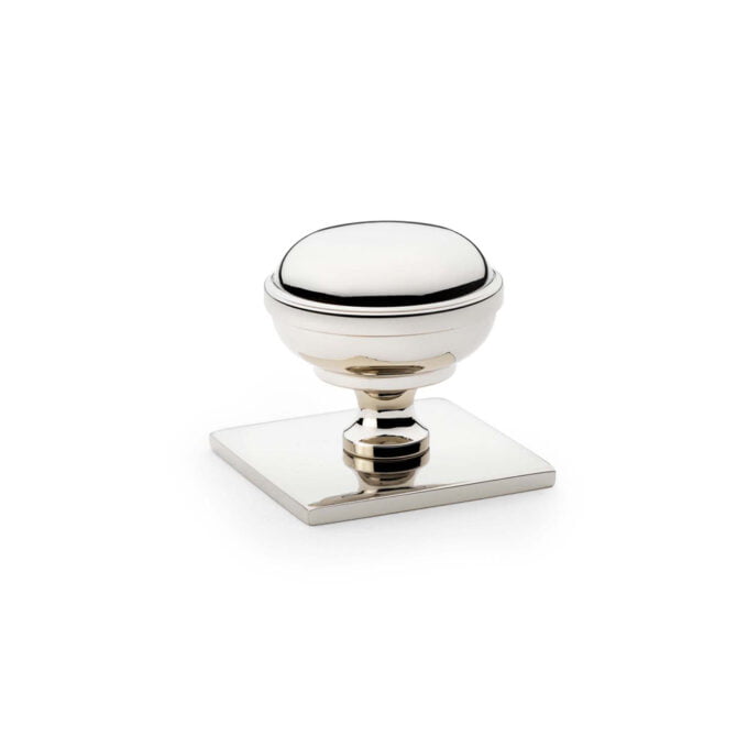 Silver and white round cabinet knob on white background