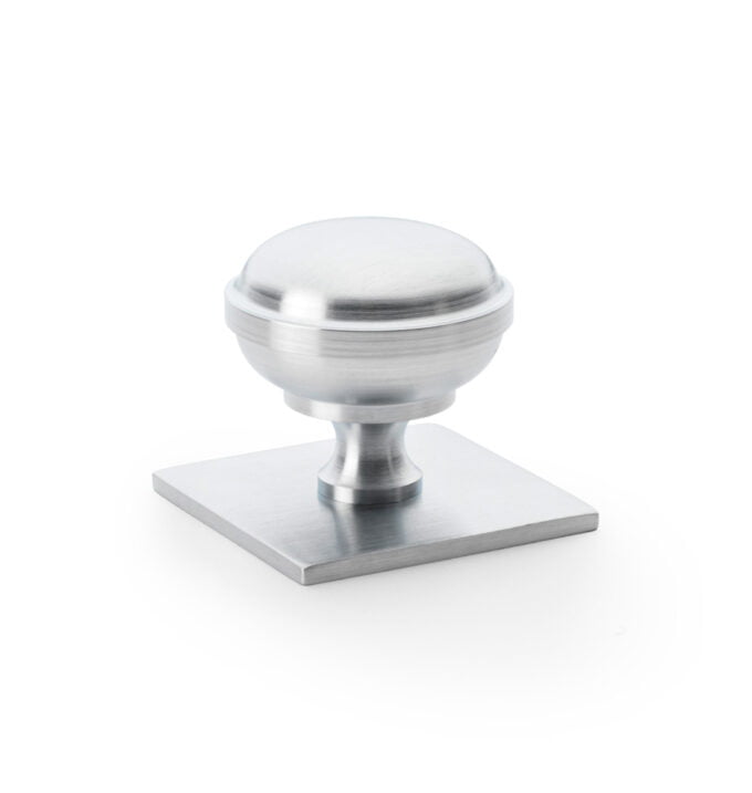 Brushed steel cabinet knob on white background