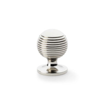 Silver striped egg-shaped cabinet door handle on white background