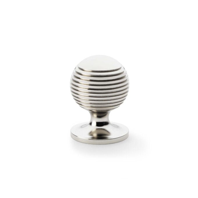 Silver striped egg-shaped cabinet door handle on white background