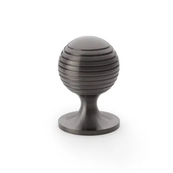 Black striped round door knob on white background