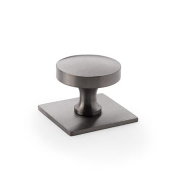Brushed nickel cabinet knob on white background.