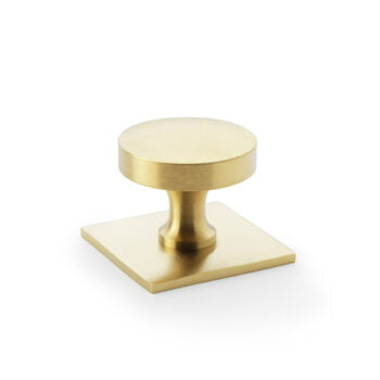 Brushed gold cabinet knob on white background