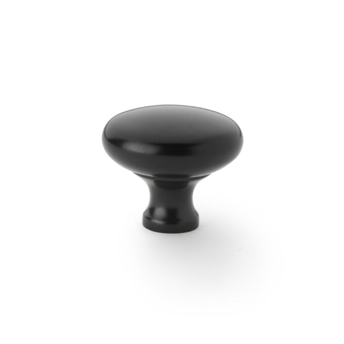 Black cabinet knob on white background.