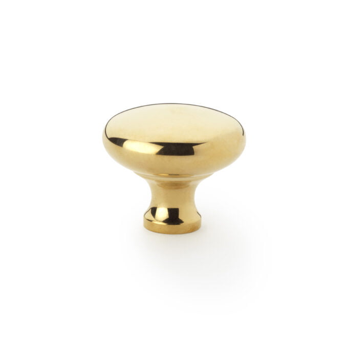 Polished gold cabinet knob against white background.