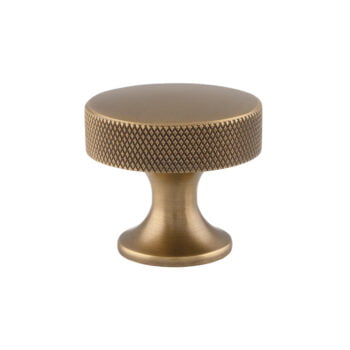 Antique brass decorative cabinet knob on white background.