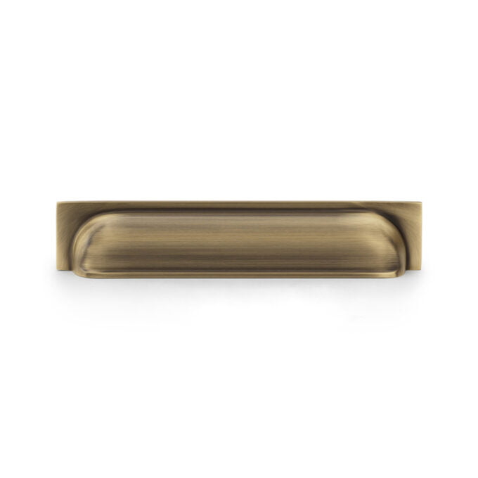 Antique brass drawer handle on white background.