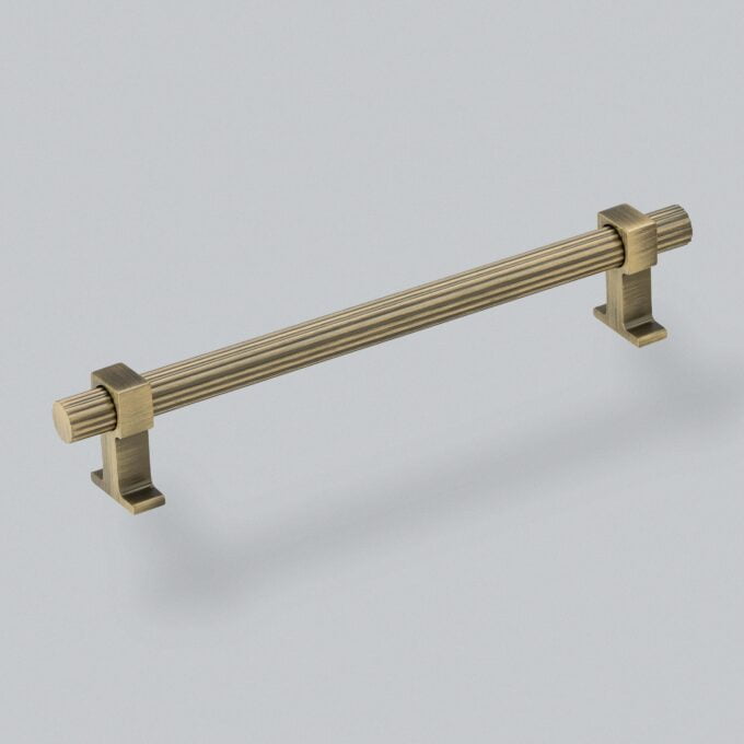 Antique brass cabinet handle on white background.