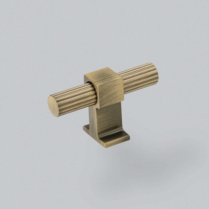 Brass cylindrical door handle on a grey background