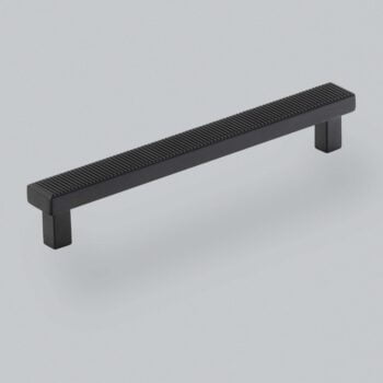 Black modern cabinet handle on white background.