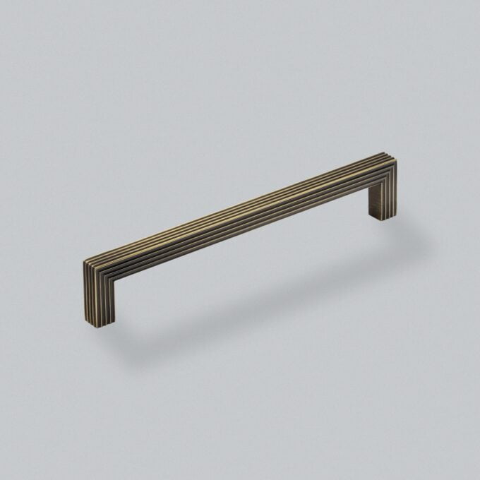 Modern brass handle on neutral background