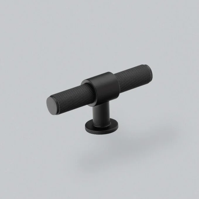 Black textured handlebar on grey background.