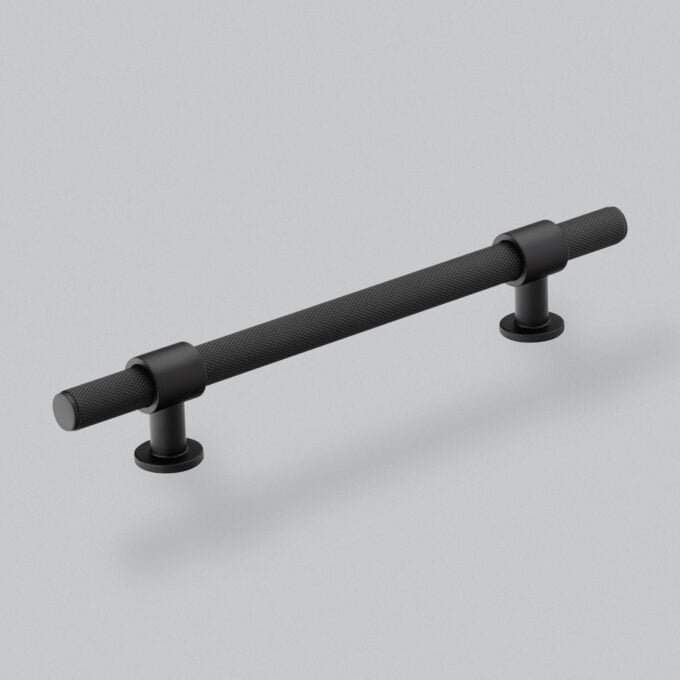 Black textured handlebar on grey background.