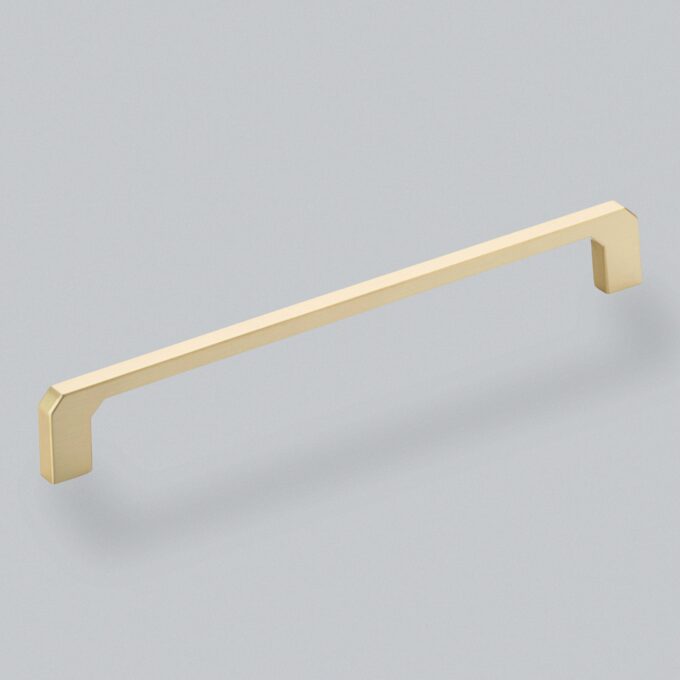 Gold cabinet handle on grey background