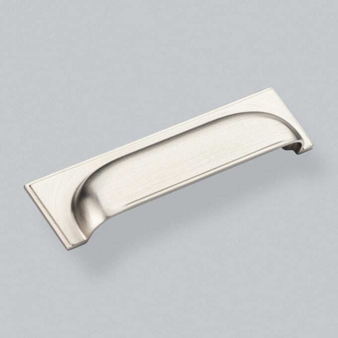 Satin nickel cupboard handle on grey background