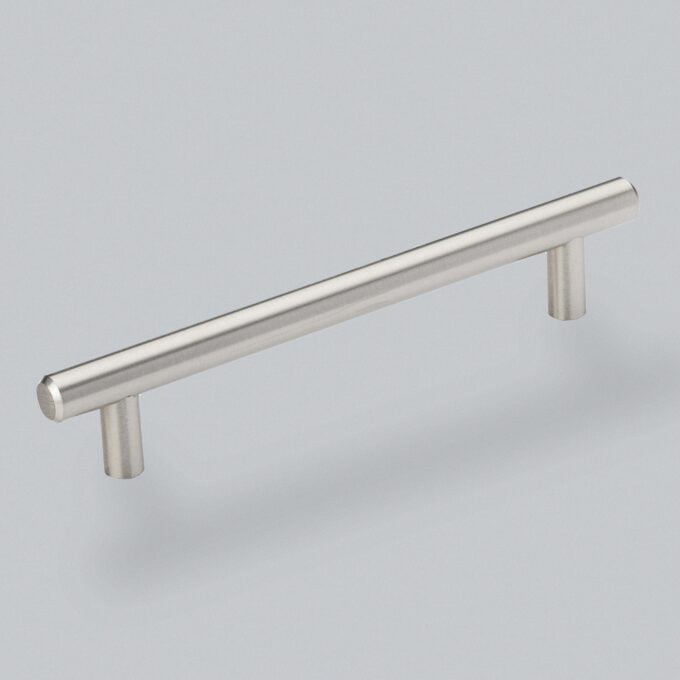 Stainless steel cabinet handle on grey background.