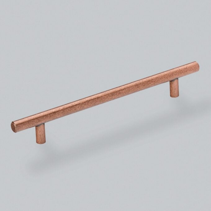 Copper cabinet handle isolated on grey background.