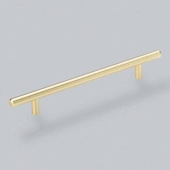 Gold cabinet handle on grey background.