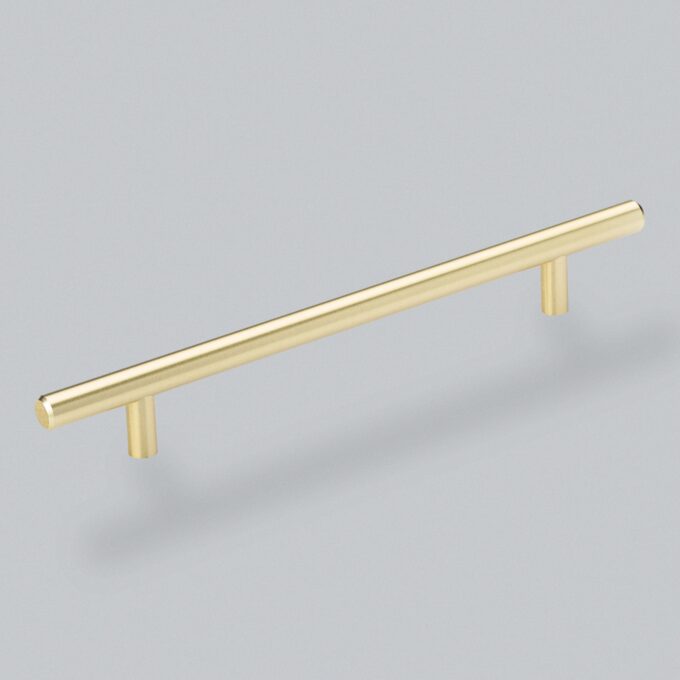 Gold cabinet handle on grey background.