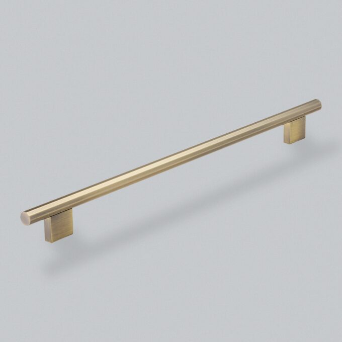 Brushed gold cabinet handle on a grey background.