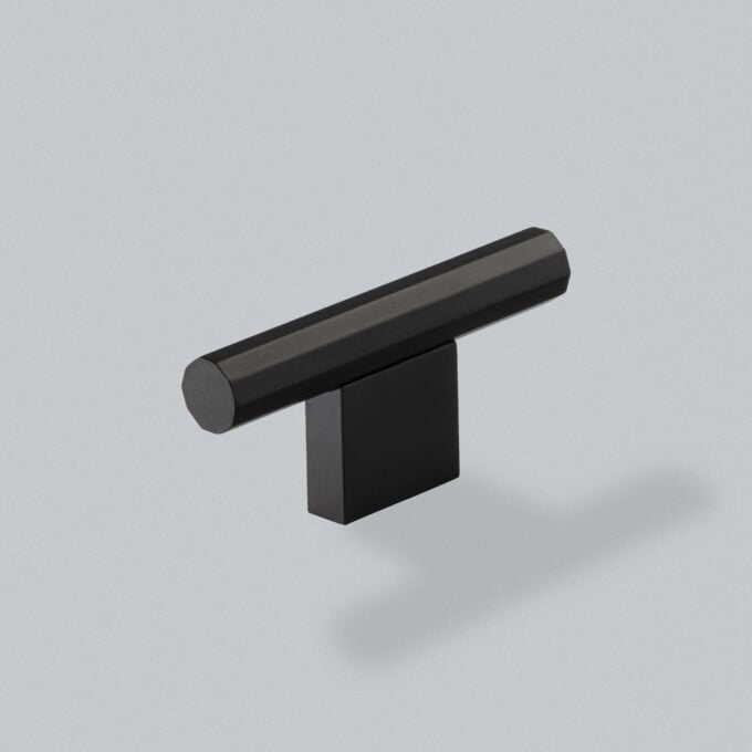 Minimalist black modern cabinet handle on grey background.