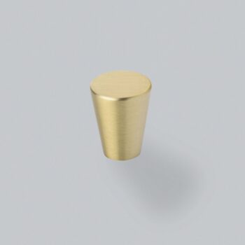 Brass cylindrical knob on grey background.