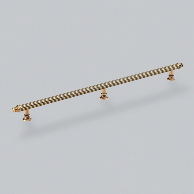 Brass cabinet pull handle on white background.