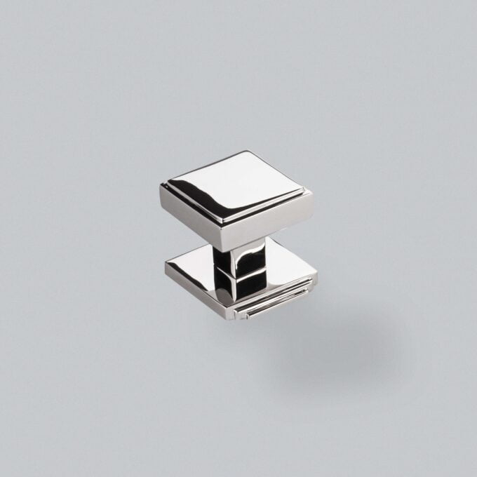 Chrome square cabinet knob on grey background