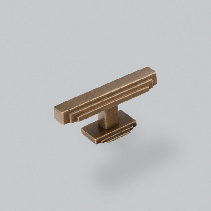 Bronze cabinet handle on grey background