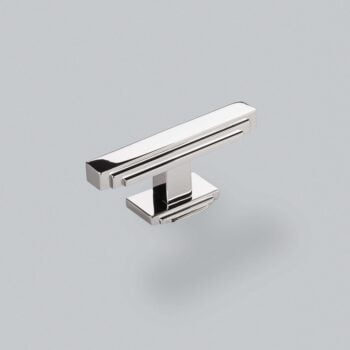 Chrome cabinet handle on a grey background.