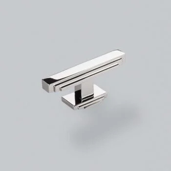 Chrome cabinet handle on a grey background.