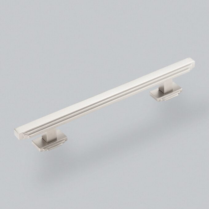 Modern stainless steel cabinet handle on gray background